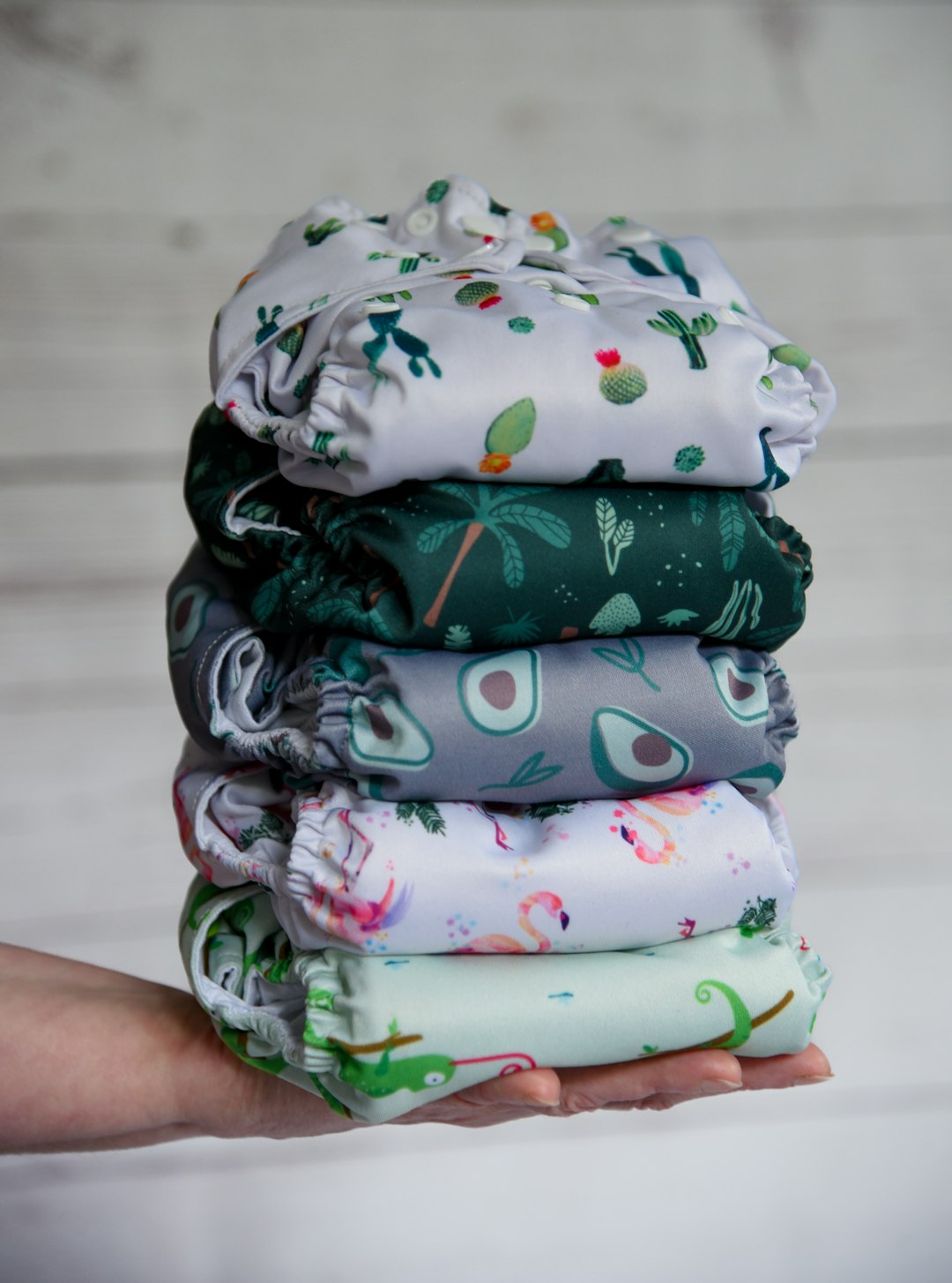 portfolio-05 Close view of a pile of cloth diapers being held in front of a neutral background