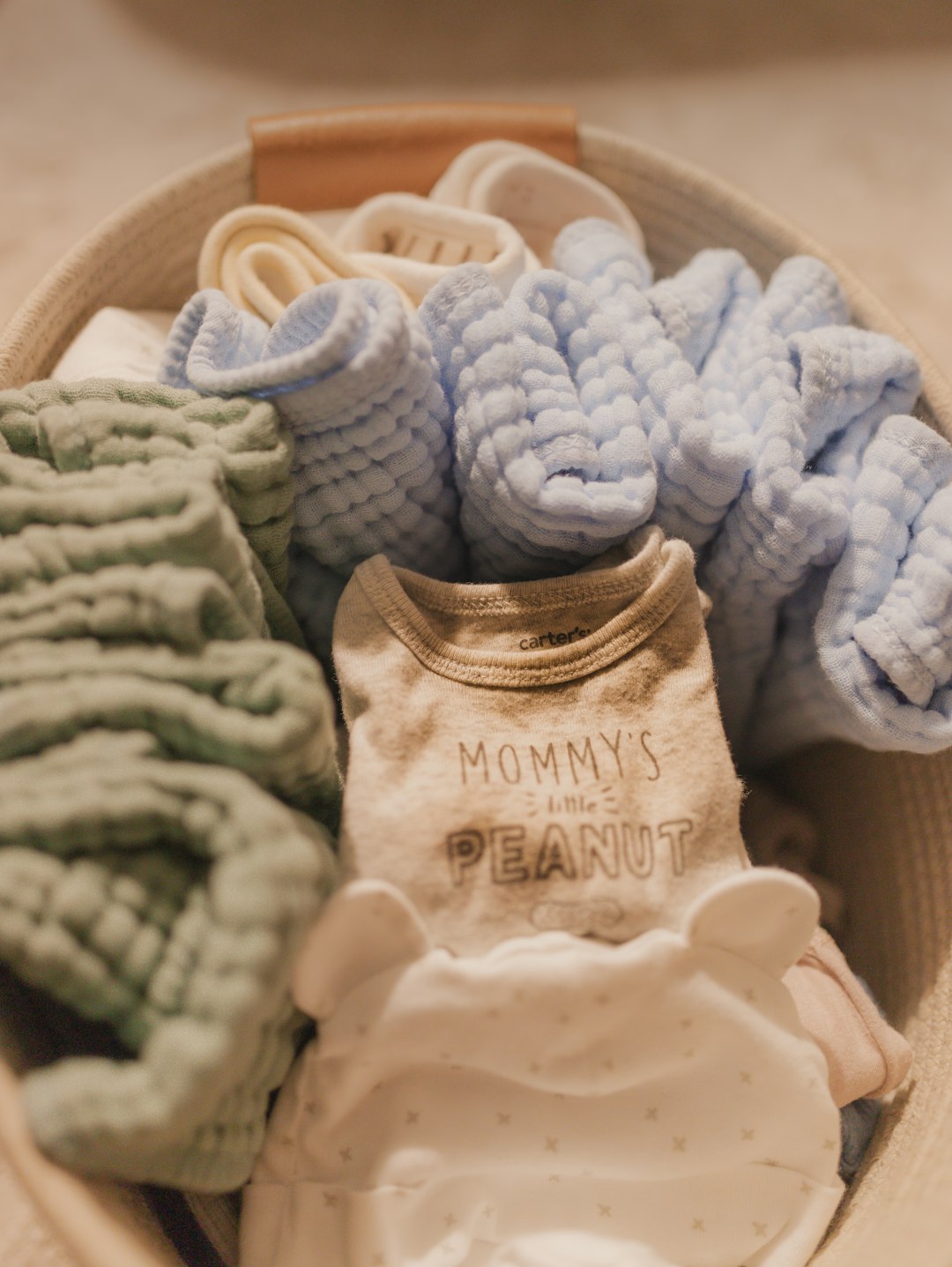 portfolio-02 Just a laundry basket of clean baby clothes and towels.