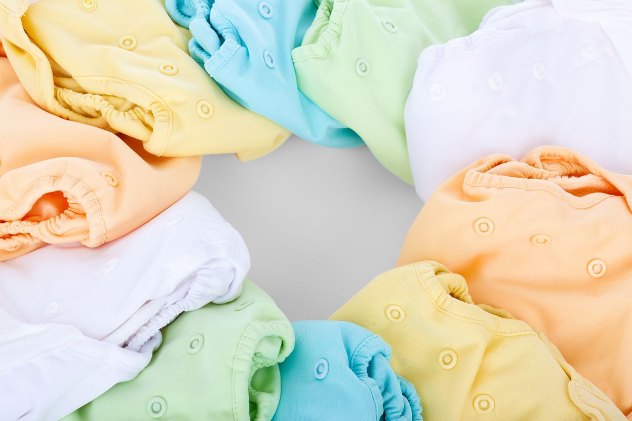 Mastering the First Impression: Your intriguing post title goes here A top-view of colorful cloth diapers arranged in a circular pattern showcasing vivid hues and comfort.